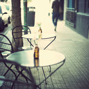 Neighborhood bistro tables and a sidewalk