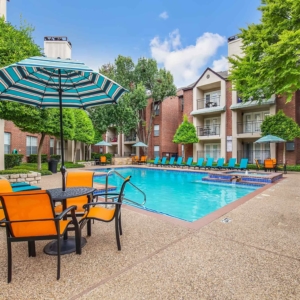 Brightly colored pool furniture with pool and hotub in the background