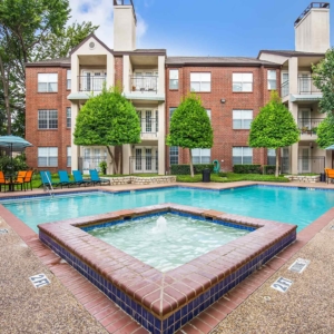 Wide view of Tonti Lakeside pool with hottub, pool and brightly colored patio furniuture